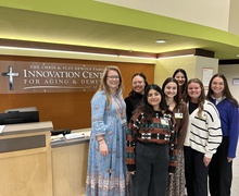 Group photo of Laura Schmitt and graduate students at the Chris and Suzy DeWolf Family Innovation Center for Aging and Dementia.