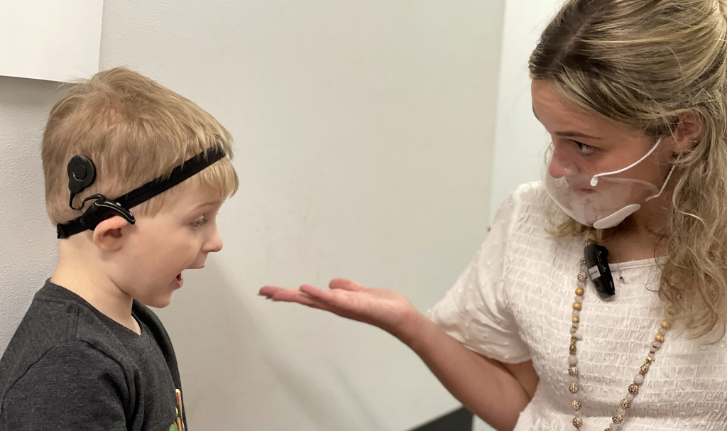 grad clinician providing speech therapy to child with CI's
