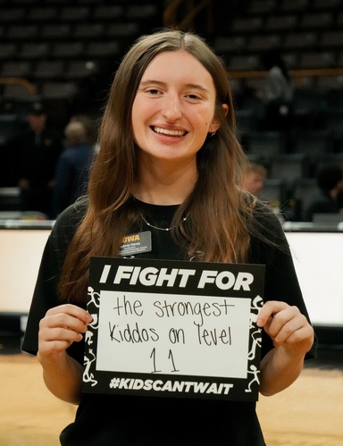 Photo of Aubrey Haney posing with a Dance Marathon sign