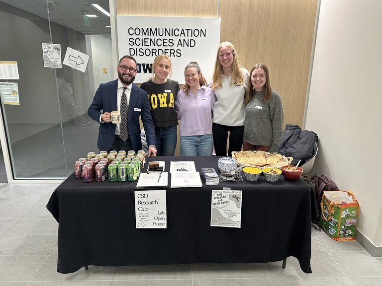 Ethan Kutlu smiles with members of the CSD Research Club