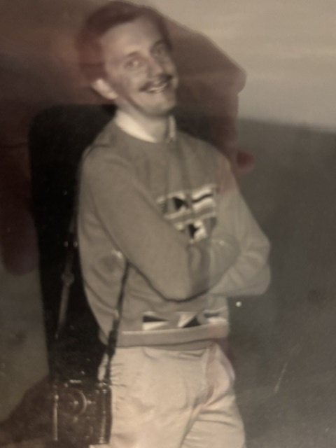 Douglas Burrows crosses his arms and smiles.