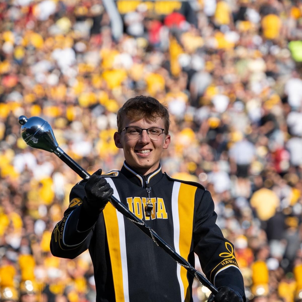 Brandon Alpers smiles during a Hawkeye Marching Band halftime performance.