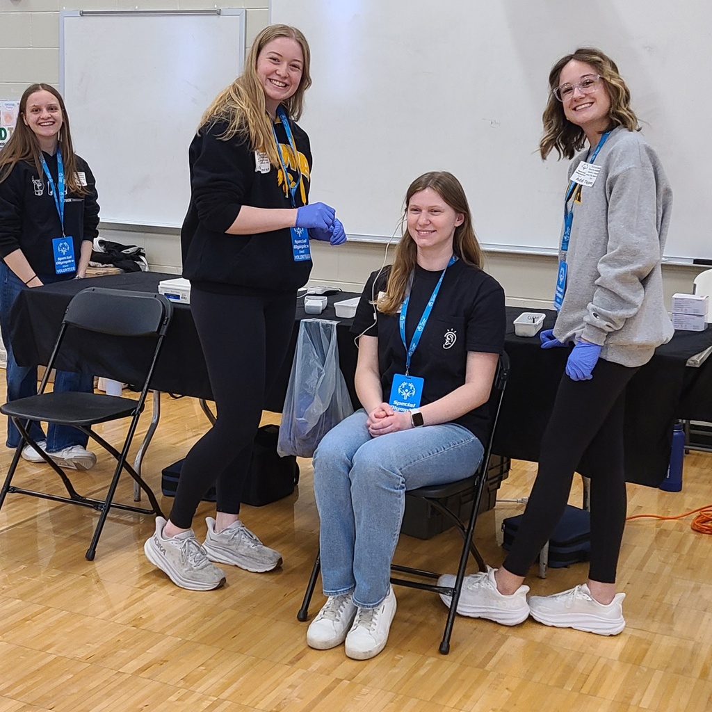 Volunteers and athletes participate in hearing screenings