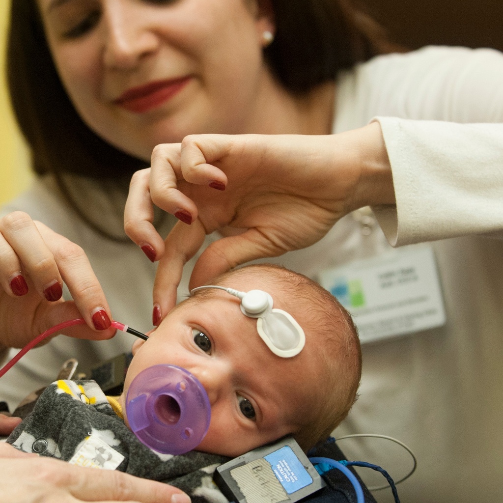 An infant receives care with clinicians through Iowa's #2 ranked audiology program