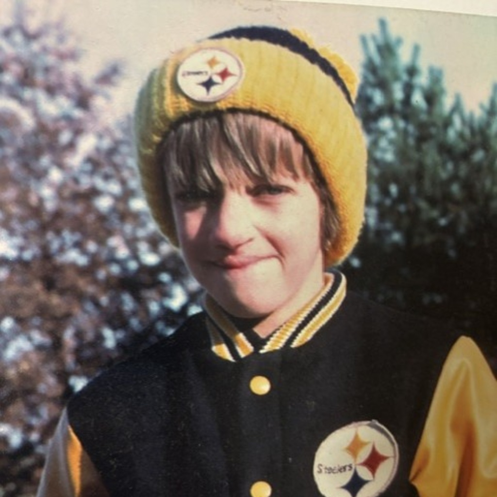 A young Douglas Burrows smiling in his Steelers gear.