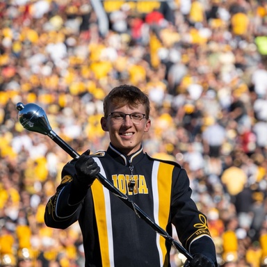 Brandon Alpers smiles during a Hawkeye Marching Band halftime performance.