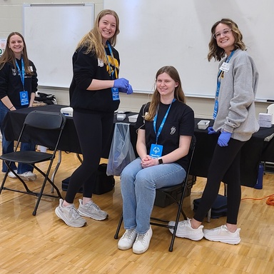 Volunteers and athletes participate in hearing screenings