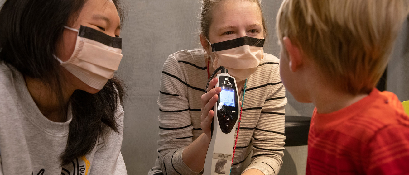 audiologists showing child sound level meter