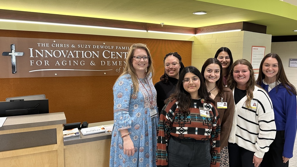 Group photo of Laura Schmitt and graduate students at the Chris and Suzy DeWolf Family Innovation Center for Aging and Dementia.