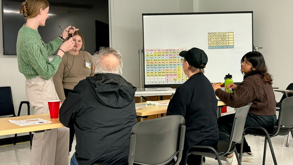 ALS lab leaders and attendees working in a classroom setting.