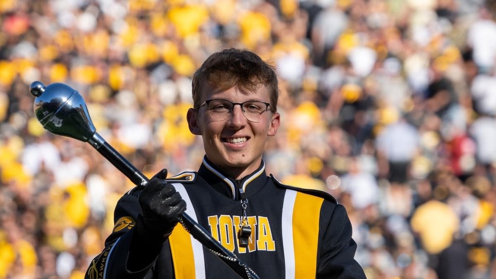 Brandon Alpers smiles during a Hawkeye Marching Band halftime performance.