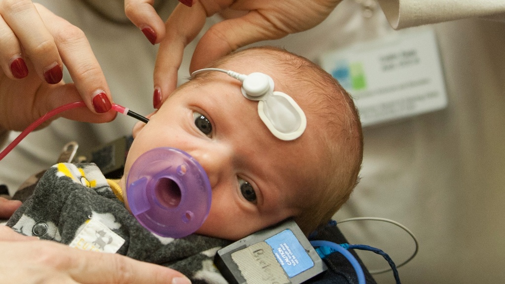 An infant receives care with clinicians through Iowa's #2 ranked audiology program