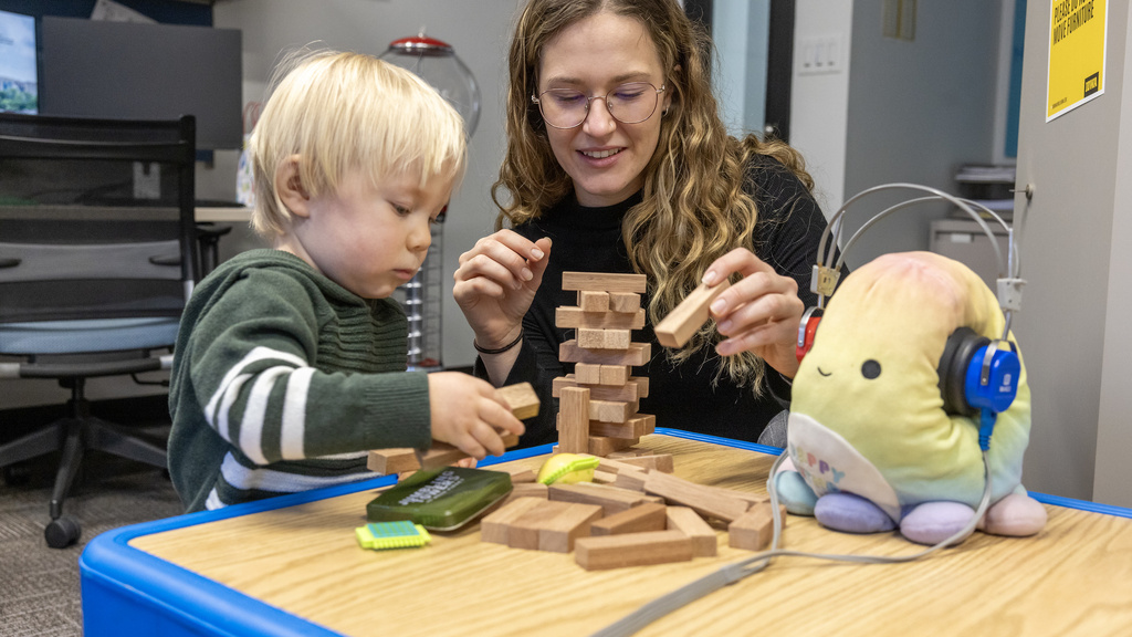 A student and child working in a CSD lab.