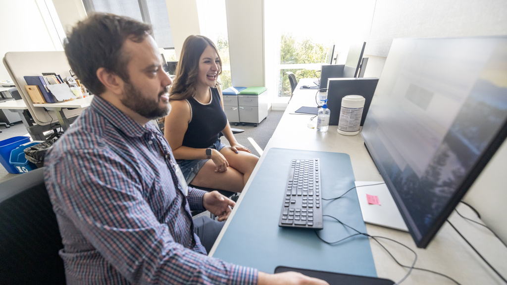 Philip Combiths research lab looking at computer screen with female student